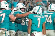  ?? LYNNE SLADKY/ASSOCIATED PRESS ?? Dolphins tight end Durham Smythe celebrates with quarterbac­k Tua Tagovailoa after Tagovailoa scored a touchdown to seal a 22-10 win over the Ravens.