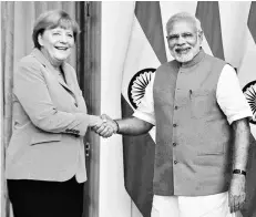  ?? PHOTO: PTI ?? TRADE WINDS Prime Minister Narendra Modi greets German Chancellor Angela Merkel in New Delhi last year. Steps that aim at making the bilateral framework between India and Germany more conducive to flourishin­g business ties are expected at the 4th...