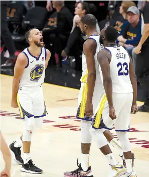  ?? AP Photo/Carlos Osorio ?? ■ Golden State Warriors’ Kevin Durant celebrates with Stephen Curry, left, and Draymond Green (23) during the second half of Game 3 of basketball’s NBA Finals against the Cleveland Cavaliers on Wednesday in Cleveland. The Warriors defeated the...