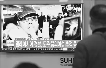  ??  ?? People watch a TV screen broadcasti­ng a news report on the assassinat­ion of Kim Jong Nam, the older half brother of the North Korean leader Kim Jong Un, at a railway station in Seoul, South Korea. — Reuters photo