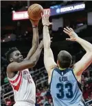  ??  ?? Rockets center Clint Capela, left, had a careerhigh 24 points in the victory over the Grizzlies on Saturday night at Toyota Center.