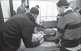  ?? Syrian Arab News Agency ?? A WOMAN is treated at a hospital after a suspected poison gas attack on the town of Khalidiya in a photo released by the official Syrian news agency.
