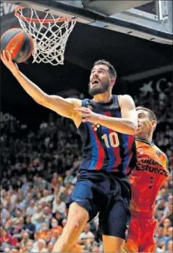  ?? ?? Nikola Kalinic, alero del Barça, lanza ante Víctor Claver, del Valencia.