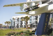  ?? Brittany Hosea-Small / Special to The Chronicle ?? Aero, a 70unit nauticalth­emed apartment building with views of the skyline, is seen behind the Alameda Point jet.