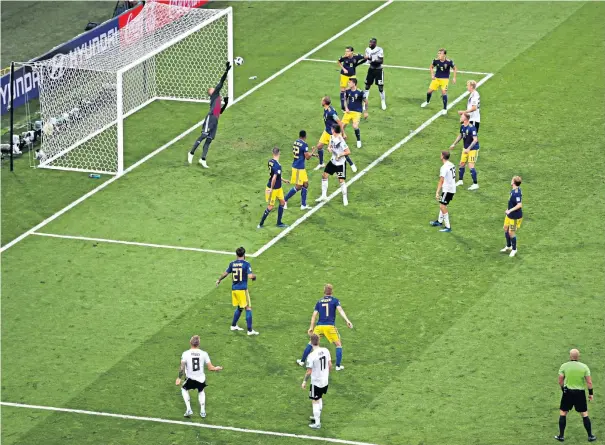  ??  ?? Breathtaki­ng finish: Germany midfielder Toni Kroos takes a short free-kick from Marco Reus and curls in a dramatic injury-time winner for the world champions to leave Sweden shattered