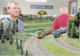  ?? STEVE HENSCHEL NIAGARA THIS WEEK ?? Greater Niagara Model Railroad Engineers member Mark Leonard keeps a close eye on his train as it rounds a bend at the club’s Fenwick home. On Nov. 17, 18, 24 and 25 the club will open its doors to the public for a run of fall open houses.