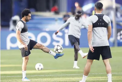  ?? AP ?? Liverpool’s Mohamed Salah (left) controls the ball during a training session at the Olimpiyski­y Stadium in Kiev, Ukraine, yesterday ahead of today’s UEFA Champions League final against Real Madrid.