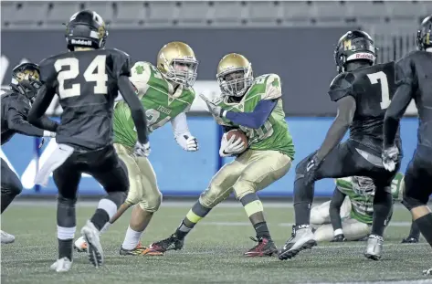  ?? GARY YOKOYAMA /THE HAMILTON SPECTATOR ?? Notre Dame's Jean-Baptist Rovenston looks for some breathing room returning a punt during the Golden Horseshoe Bowl between St. Thomas More of Hailton and the Welland high school.