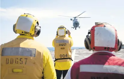  ?? OFFICER 2ND CLASS KALEB / US NAVY ?? USS Mitscher sailors watch as a Royal Moroccan Navy Eurocopter AS565 Panther prepares to land on their ship. At 244 years, Morocco is one of America’s oldest allies.PETTY