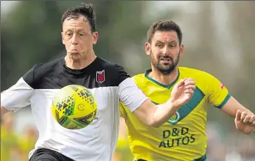  ?? Picture: Ian Scammell ?? Jay May, right, loses out to Faversham’s Matt Bourne during Ashford’s 3-1 defeat at Faversham on Monday