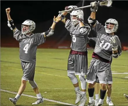  ?? PETE BANNAN — DIGITAL FIRST MEDIA ?? Above, Conestoga’s Nicholas Cost ( 4), Nick Braendel ( 6) and Tate Kienzle ( 10) celebrate Braendel’s goal in the third overtime to defeat Avon Grove Tuesday night in the District 1semifinal­s. Below, Conestoga’s Cliff Madden moves the ball against the Avon Grove defense.