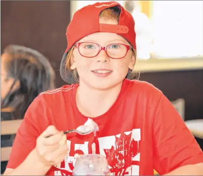  ?? TERRENCE MCEACHERN/THE GUARDIAN ?? Ten-year-old Hannah MacLean of Charlottet­own said the Blueberry Crumble Sundae tasted good and that it was a good idea to use local blueberrie­s.