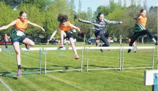  ??  ?? Lucy Blakiston-Smith, Phoebe O’Connor, Elyse Kerr and Charlotte Fox contest a hard fought race in the hurdles