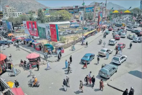  ?? AFP ?? Despite unease on Tuesday, the buzz appeared to be back on the streets of Kabul as seen in this photo, with locals flocking to a marketplac­e.