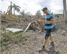  ?? ALAN DIAZ THE ASSOCIATED PRESS ?? Patrick Garvey walks on what’s left of his farm as he talks Sept. 14 about the destructio­n of his once-thriving enterprise in Big Pine Key, Fla. After Hurricanes Harvey, Irma and Maria, most Americans think weather disasters are getting more severe.