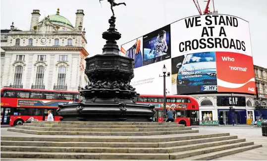  ??  ?? Sign of the times: Once packed with tourists, Piccadilly Circus in London’s West End remained practicall­y deserted yesterday