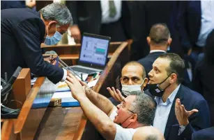  ?? (Noam Moskowitz/Knesset) ?? KNESSET SPEAKER Mickey Levy (left) debates with Likud MKs David Bitan and Miki Zohar in the plenum yesterday after his vote stymied the passing of a coalition bill.