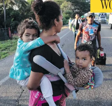  ?? GUILLERMO ARIAS / AFP / GETTY IMAGES ?? Migrants heading in a caravan to the U.S., walk along the road from La Ventosa to Matias Romero, Mexico.