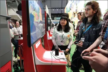  ?? The Associated Press ?? GATHERING OF GAMERS: Visitors to the Pax East conference play the new Nintendo Switch video game Animal Crossing on Feb. 27 in Boston.