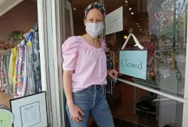  ?? MATT STOnE pHOTOS / HERALd STAFF ?? RARING TO GO: Mint Julep owner Brooke Garver stands in front of her clothing store in Brookline on Monday. She was hoping to reopen her store fully next week but it looks like she’ll have to wait.