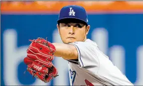  ?? AP/JULIE JACOBSON ?? Yu Darvish delivers a pitch against the New York Mets in his first game with the Los Angeles Dodgers on Friday night. Darvish, who was traded from the Texas Rangers on Monday, allowed no runs and 3 hits, striking out 10, in a 6-0 victory.