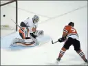  ?? PAUL BEATY/ THE ASSOCIATED PRESS ?? Blackhawks left wing Artemi Panari snaps the decisive shootout goal past Islanders goalie Thomas Greiss in Chicago’s 2-1 win Friday at the United Center.