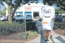  ?? LAUREN HALLIGAN — MEDIANEWS GROUP FILE ?? A giant coffee cup character waves to passersby at the Saratoga Springs Dunkin’ location.