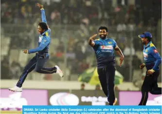  ??  ?? DHAKA: Sri Lanka cricketer Akila Dananjaya (L) celebrates after the dismissal of Bangladesh cricketer Mushfiqur Rahim during the final one day internatio­nal (ODI) match in the Tri-Nations Series between Bangladesh and Sri Lanka in Dhaka yesterday.— AFP