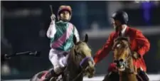  ?? THE ASSOCIATED PRESS ?? Mike Smith, on top of Arrogate, celebrates the Dubai World Cup on Saturday. after winning