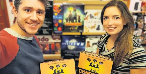  ??  ?? Ceri Price, from Llanelli, and his girlfriend Natalie Podd with their board game CONFIDENT? which is now being sold on Amazon.