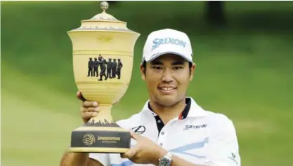  ??  ?? AKRON: Hideki Matsuyama, from Japan, holds up The Gary Player Cup trophy after the final round of the Bridgeston­e Invitation­al golf tournament at Firestone Country Club, Sunday, in Akron, Ohio. Matsuyama finished the tournament at 16-under par.—AP