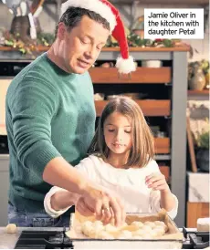  ??  ?? Jamie Oliver in the kitchen with daughter Petal