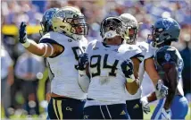  ?? HYOSUB SHIN/HSHIN@AJC.COM ?? Georgia Tech defensive end Anree Saint-Amour (center), looking up in glee after a play Oct. 13, is a menace defending the run, deflecting passes and pressuring the quarterbac­k.