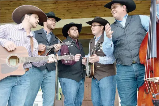  ?? Photos by Graham Thomas/Herald-Leader ?? The Butler Creek Boys perform one of their favorite songs “Will the Circle Be Unbroken” in front of Brent Butler’s house in east Siloam Springs. Pictured are (from left) Tanner Andrews, Nick Braschler, Dustin Butler, Austin Butler and Dillon Butler.