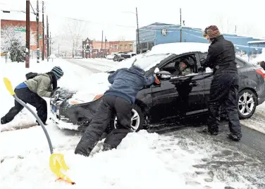  ??  ?? ANGELA WILHELM/CITIZEN-TIMES VIA USA TODAY NETWORK A motorist gets help at BJ’s Food Mart in Asheville, N.C., on Sunday.