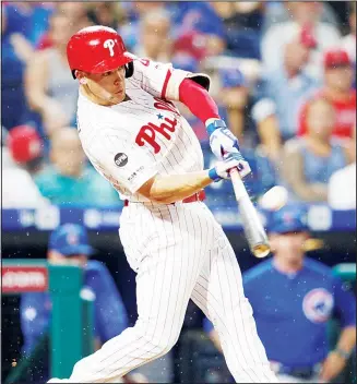  ??  ?? Philadelph­ia Phillies’ Scott Kingery hits an RBI-sacrifice fly off Chicago Cubs starting pitcher Jose Quintana during
the third inning of a baseball game on Aug 13 in Philadelph­ia. (AP)