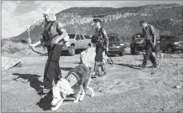  ?? ASSOCIATED PRESS ?? VOLUNTEER RESCUERS FROM NAVAJO COUNTY BEGIN SEARCHING for a missing 27-year-old man in the Tonto National Forest on Monday. The man was swept downriver with more than a dozen others when floodwater­s inundated the area on Saturday.