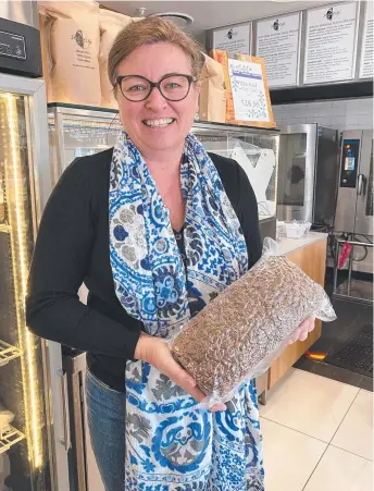  ?? ?? Seeds of Life co-founder Heidi Wiltshire with the 3kg $135 Thor high-protein loaf. Picture: Ann Wason Moore