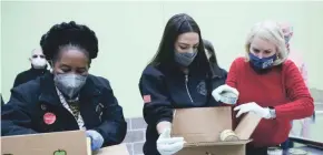  ?? ELIZABETH CONLEY/HOUSTON CHRONICLE VIA AP ?? U.S. Reps. Sheila Jackson Lee, from left, Alexandria Ocasio-Cortez and Sylvia Garcia fill boxes at the Houston Food Bank on Saturday. President Joe Biden has declared a major disaster in Texas.