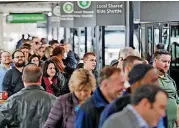  ?? [AP PHOTO] ?? With the SkyTrain out of service, travelers are directed to a long line for shuttle buses Monday at Hartsfield-Jackson Internatio­nal Airport in Atlanta. Power was restored at the airport after a massive outage Sunday afternoon that left planes and...