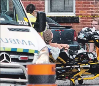  ?? BOB TYMCZYSZYN THE ST. CATHARINES STANDARD ?? A third patient is taken away as police search for suspects after a shooting in the downtown area of St. Catharines Thursday afternoon.