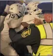  ?? ASSOCIATED PRESS FILE PHOTO ?? Security and police break up a scuffle between players from Michigan and Michigan State in the Michigan Stadium tunnel after last month’s game. Seven MSU players were charged in connection with the melee.