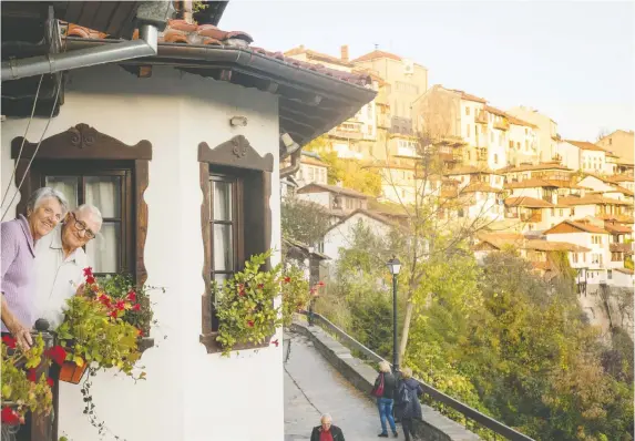  ?? PHOTOS: DINA MISHEV/THE WASHINGTON POST ?? The author’s parents take in the views at Hotel Gurko in Veliko Tarnovo, which is built on a steep hillside above the Yantra River.