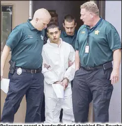  ?? AP ?? Policemen escort a handcuffed and shackled Sky Bouche to a waiting patrol car in Ocala, Florida on Friday.