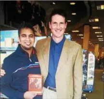  ??  ?? Author Bill Brewer, right, poses with Asif Hashim at a recent book signing event.