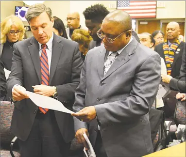  ?? Cassandra Day / Hearst Connecticu­t Media ?? Above, two attendees share a document at City Hall Council Chambers Friday afternoon. Middletown faith leaders, state officials and community stakeholde­rs gathered to discuss a statewide economic developmen­t initiative aiming to revitalize urban centers whose streets bear the name of civil rights leader Martin Luther King Jr. The hope is it will become a model for the state and nation, organizers say. Below, Middletown Mayor Dan Drew speaks.