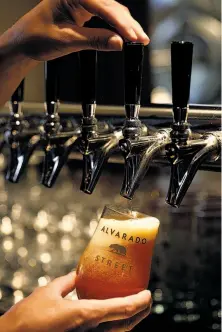  ?? Sarah Rice / Special to The Chronicle ?? J.C. Hill pours a Double Cone IPA at Alvarado Street Brewery & Grill in downtown Monterey.