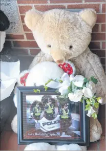  ?? STU NEATBY/THE GUARDIAN ?? A monument to the four Fredericto­n residents killed in a shooting Friday morning steadily grew over the course of the weekend. This teddy bear and photo pays tribute to police constable Sara Mae Burns, who her family said in a statement “absolutely loved her job, and went to work each shift committed to serving this great community.”