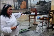  ?? RECORDER PHOTO BY ESTHER AVILA ?? Mari Perez-ruiz, Executive Director for Central Valley Empowermen­t Alliance points to numerous charred backpacks lined against a fence. While shedding tears she talks of the 400 backpacks that were packed and ready for distributi­on Friday afternoon. A rouge fire that started with a tree destroyed several businesses.