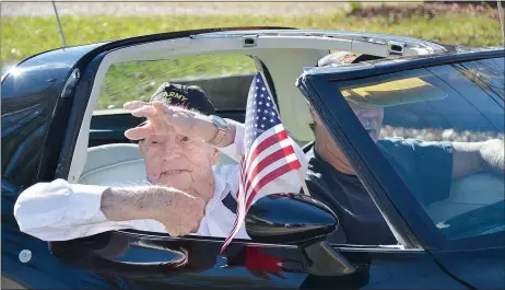  ?? TIMES photograph by Annette Beard ?? Ralph Thornton, World War II veteran, waved at bystanders from a black Corvette during the Veterans Parade Saturday.